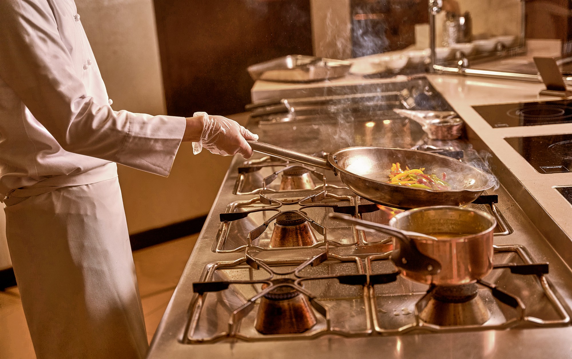 Small commercial kitchen with chef and utensils